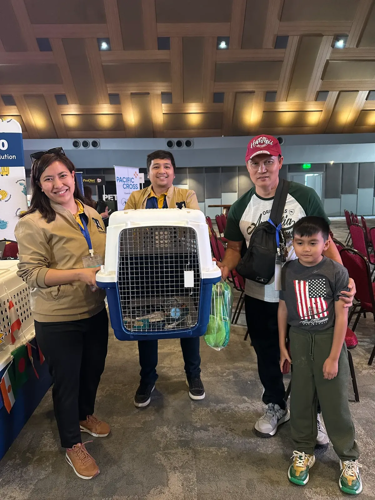 A family collecting a travel crate from our team during the three-day event.